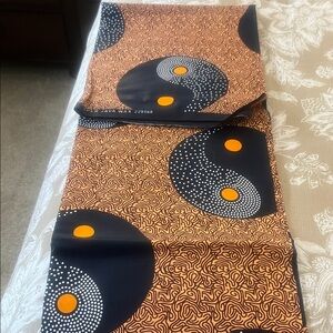 African Wax Print Fabric with Bold Black & Orange Yin-Yang Motif 70” x 45”.
